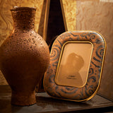 photo frame with intricate patterns on a textured surface.