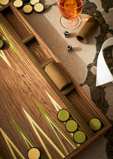 Wooden dice tray with dice and a glass of whiskey on a textured surface