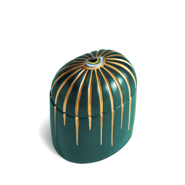 Dark green cylinder candle with gold details dripping from top eye motif
