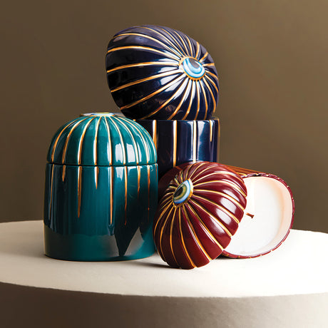 Three decorative ceramic containers with unique designs on a neutral background