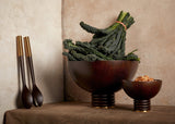 Set of 2 Alhambra hand-carved, fine smoked ash bowls floating on stacked wood pedestal with a brass base.  Alhambra  serving utensil set.