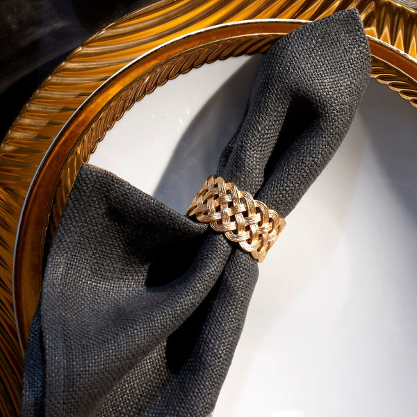 Dinnerware setting with corde gold pattern, black napin, gold Braid motif napkin ring