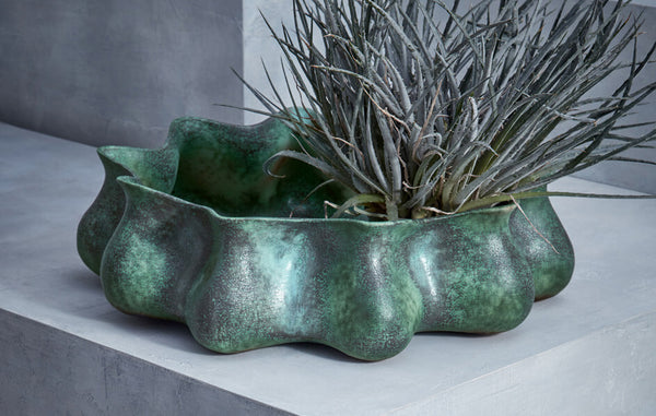 Large, shallow decorative bowl with organic, undulating form glazed aquatic blue-green.