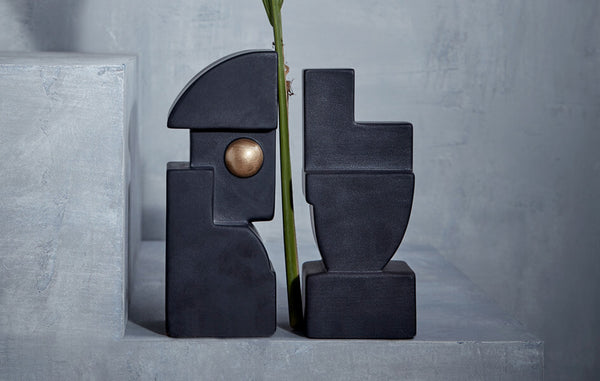 Set of 2 abstract form earthenware bookends glazed matte black with brass accents.