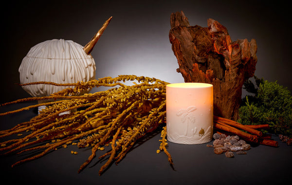 Lit porcleain candle with glowing Mojave Desert landscape suface design, sculpted porcelain monster candle vessel, desert vegetation