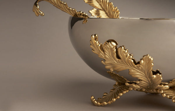 Metal serving bowl with gold acanthus leaf motif base.