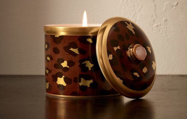 Porcelain leopard print candle vessel with rose quartz cabochon finial on lid.