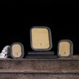 Group of platinum cuban link-motif picture frames with L'Objet logos and white porcelain skull (not available for purchase)