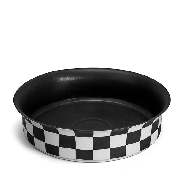 Black and white checkerboard glaze pattern on a low, round porcelain bowl with a flared rim shape. 