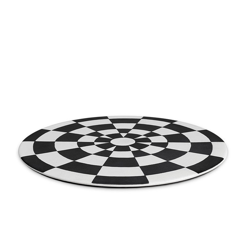 Black and white checkerboard glaze pattern on a low, rimless porcelain platter, laid down