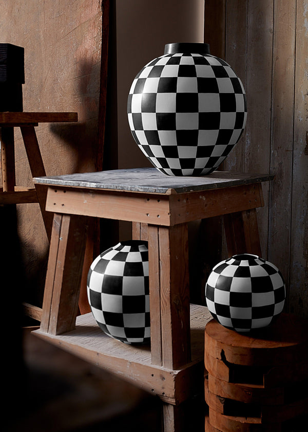 Damier Vases with black and white checkerboard glaze pattern on orb-shaped porcelain vases.