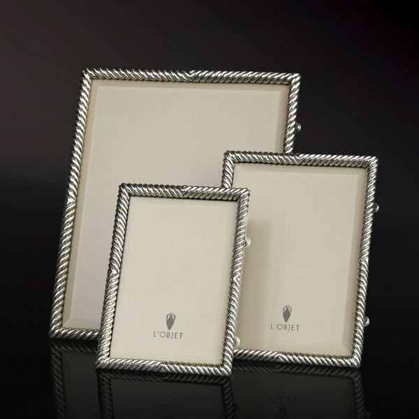 Group of platinum twist-motif picture frames with L'Objet logos.