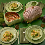 Tabletop with L'Objet Haas Brothers Matcha green dinnerware and pink Lukas Soup Monster Tureen