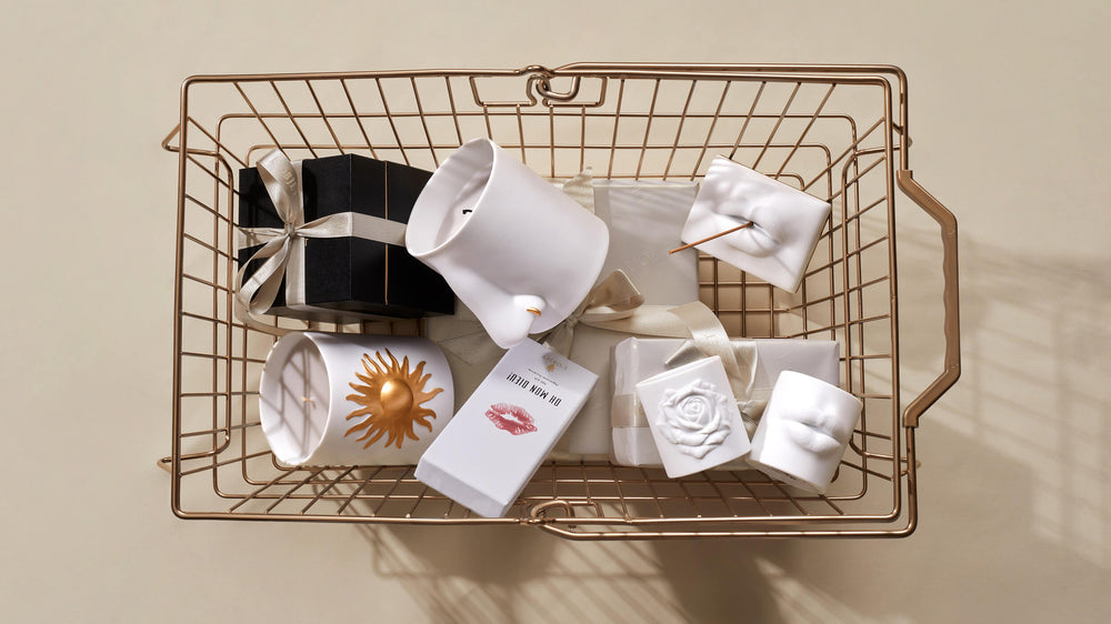 Basket with various items including a mug, soap, and a candle on a beige background
