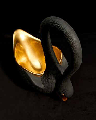 Black Porcelain Swan Bowl with 24K Gold Interior. Shot from 3/4 Above on a black matte background.