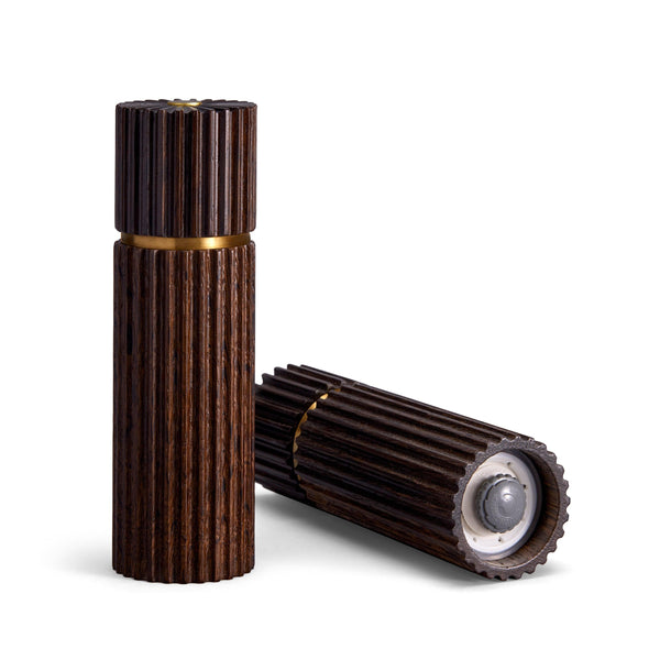 Architectural salt and pepper mills are hand carved in smoked oak with metal grinding mechanism