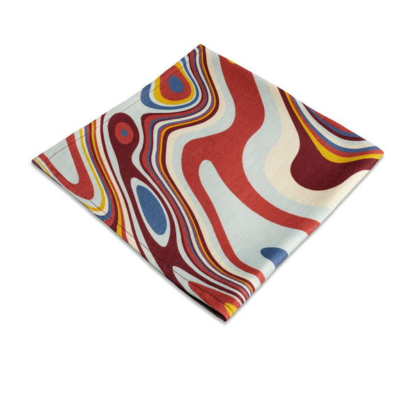 Linen napkins with an organic, psychedelic pattern in red, blue, yellow and ivory hues.