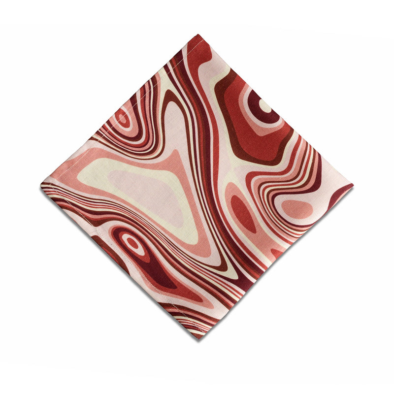 Linen napkins with an organic, psychedelic pattern in red, pink, yellow, brown and ivory hues.