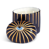 dark blue candle with three wick styled with eye motif top to the side