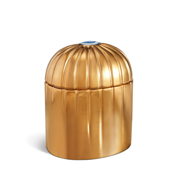 gold cylinder candle with details dripping from top eye motif
