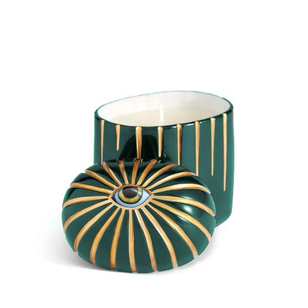 Dark green cylinder candle with one wick posed with its eye motif topper
