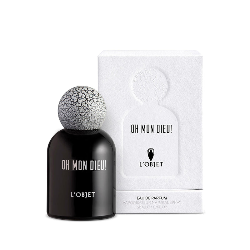 black bell shaped glass bottle with round crackle top in front of a white paper matte packaging box