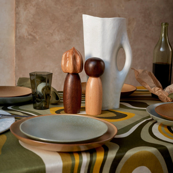 Linen Sateen waves green and yellow tablecloth, Terra stone glazed pitcher and Pictanto wooden Spice mills with organic, curved forms.