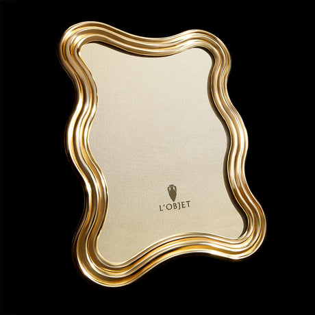 24K Gold Ripple Frame. New Arrivals. Arranged in front of a flat black background.