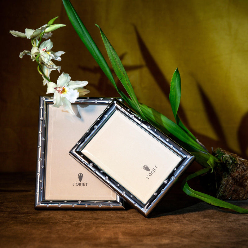 Pair of platinum and crystal star-motif picture frames with L'Objet logos.