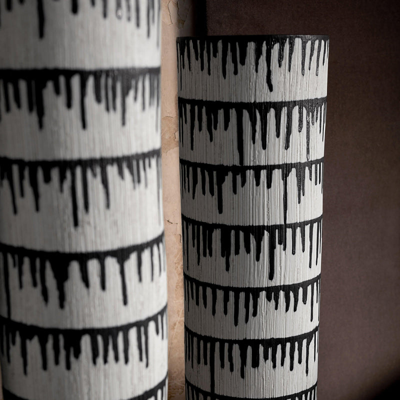 Group of handmade porcelain decorative bowls and vases with indigo dye drops to flowing down from the rim.